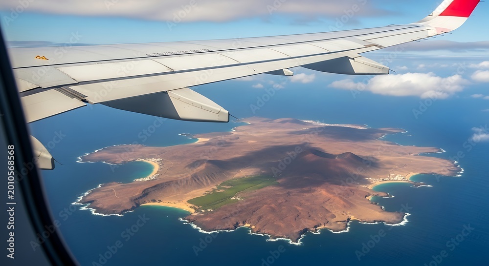 Obraz premium Aerial view of an island with coastline and ocean from an airplane window