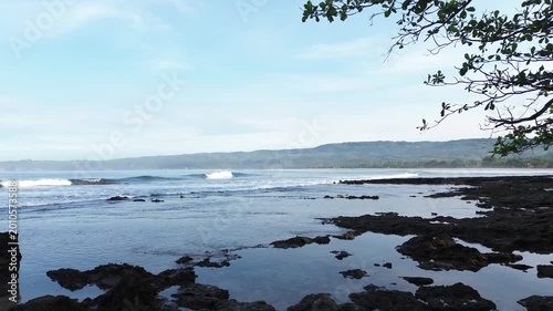 Beautiful Tropical Beach with Rocky Shoreline and Ocean Waves