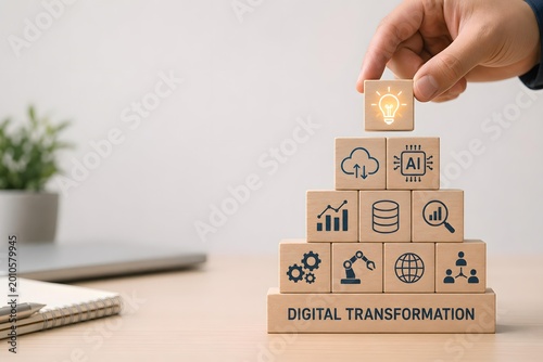 Hand Placing Light Bulb Block on Top of Digital Transformation Pyramid for Business Innovation