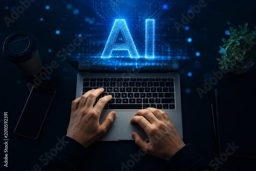 Overhead shot of hands on MacBook with glowing AI text projection, blue digital particles floating in air, dark background subtle blue ambient light, ultra realistic