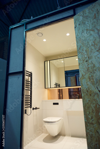 Prefabricated modular bathroom pod units in a factory with plumbing, sink, shower, bath and electrics installed ready for hotel and high rise apartment construction