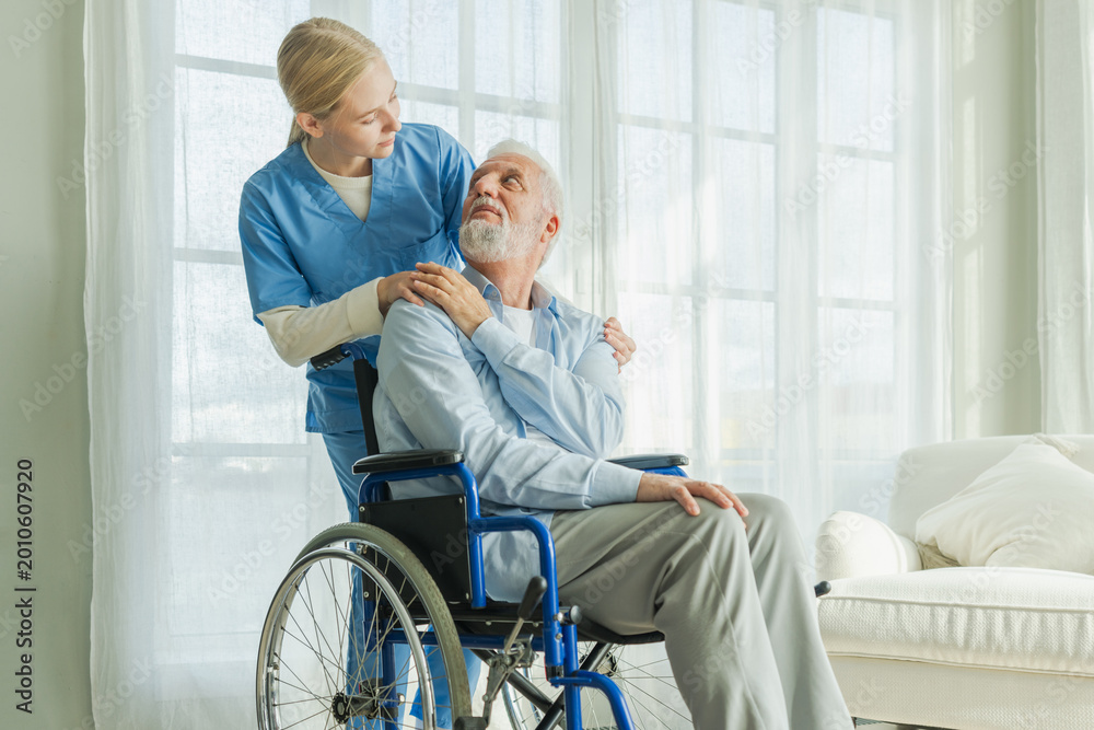 Obraz premium Help support retirement healthcare. Nurse helping old man in wheelchair. Patient and woman in nursing home for medical caregiver. Nurse taking care of paralyzed man in chair for people with disability