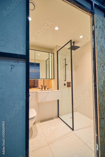 Prefabricated modular bathroom pod units in a factory with plumbing, sink, shower, bath and electrics installed ready for hotel and high rise apartment construction