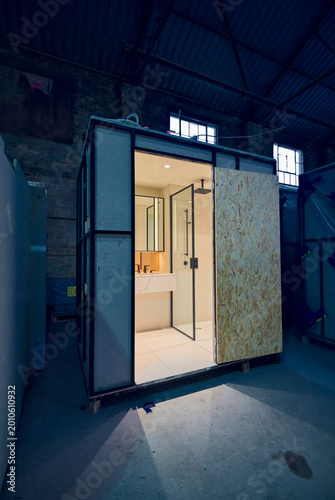 Prefabricated modular bathroom pod units in a factory with plumbing, sink, shower, bath and electrics installed ready for hotel and high rise apartment construction
