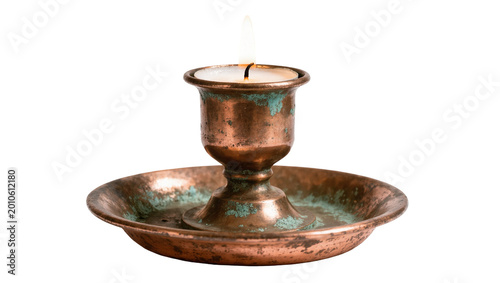 Fotografia Antique Copper Candleholder with Teal Patina and Burning Flame