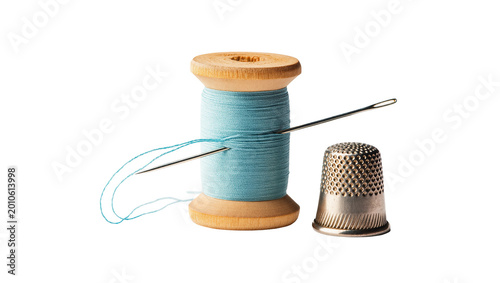 Schilderij op canvas Wooden spool light blue thread sewing needle silver thimble
