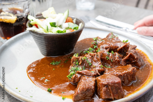 Foto Flemish beef stew with mixed salad plate