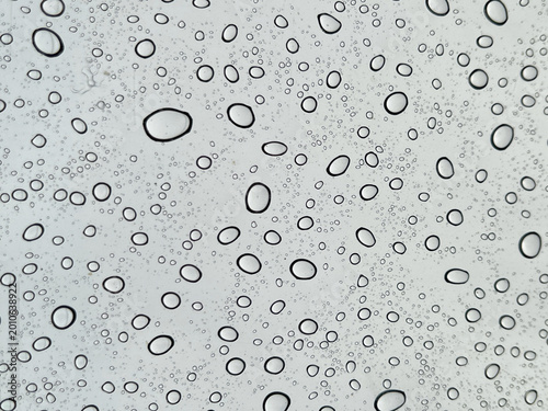 Water droplets on glass surface creating abstract pattern texture, perfect for freshness and clean concept