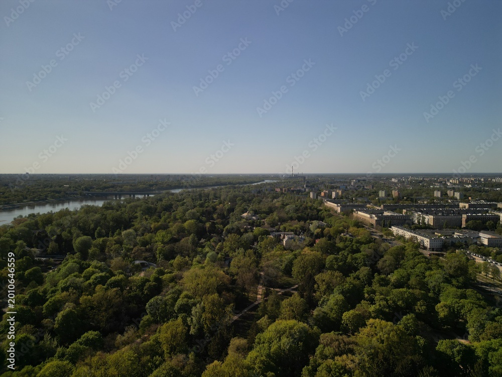 Fototapeta premium Warszawa - Polska - panorama Warszawy wykonana dronem. Rzeka Wisła, kościół, wieżowce, bloki, ulice w słoneczny dzień