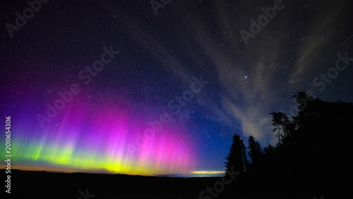 Bild auf Leinwand Aurora Borealis, igniting below the Milky Way at Winters Gibbet, Northumberland,