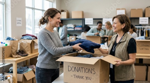 Woman donating clothes to another woman at charity organization indoors  