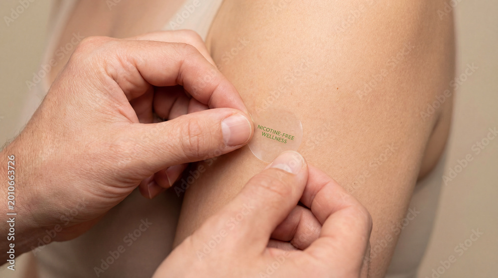 Fototapeta premium Hands apply transparent wellness patch to upper arm showing discreet self care product daily habit body care routine modern personal health support non invasive solution lifestyle innovation