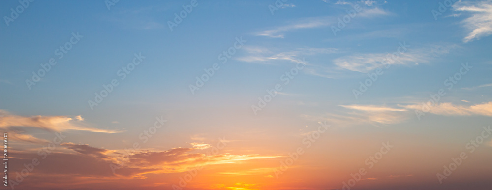 Εκτύπωση καμβά Panoramic sunset sky background with vibrant orange and golden clouds under a so