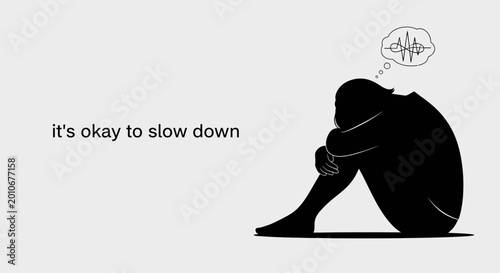 Bild auf Leinwand A person sitting curled up in a silhouette representing mental health and slowing down