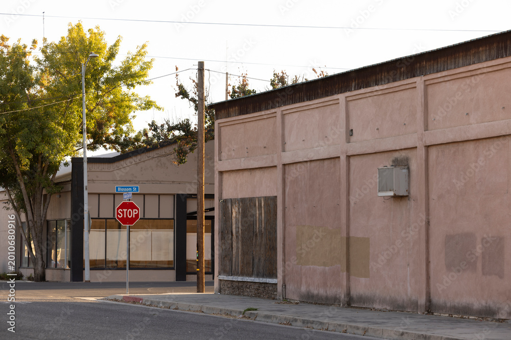 Naklejka premium Sunset light illumiantes historic buildings in downtown Dos Palos, California, USA.