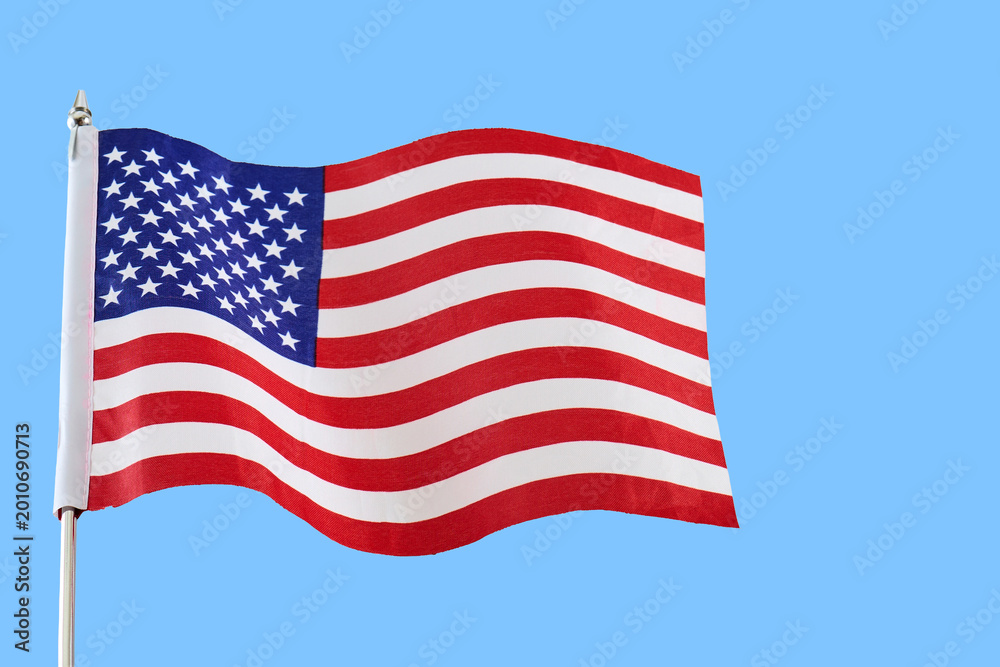 Fototapeta premium American flag waving in blue sky representing patriotism