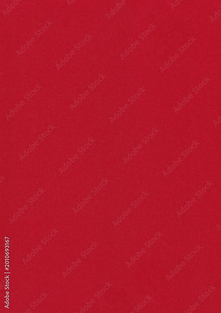 Fototapeta premium Solid vibrant red paper texture with a subtle grain. Minimalist background featuring a clean surface and a torn paper edge effect for creative design projects. Vertical textured paper backdrop.