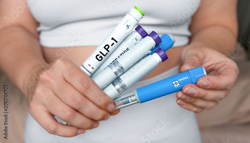 Obraz na plátně Woman holding multiple GLP-1 injection pens, weight loss and diabetes treatment