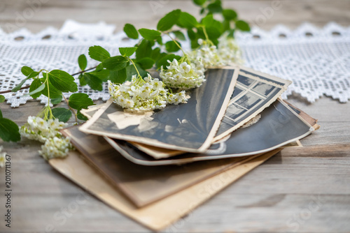 Canvas Print stack vintage family photographs, aged paper prints, wooden table surface, shall