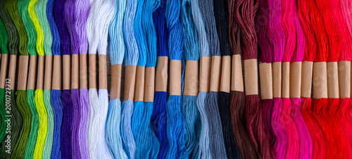 Tableau sur toile Colorful embroidery floss skeins in vibrant rainbow hues, cascade multicolored f