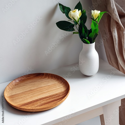 Wooden Plate and Vase With Flowers on a Table in a Bright Room