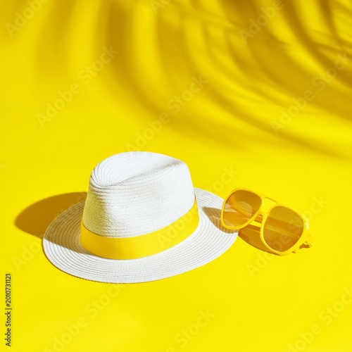 Bright Yellow Hat and Sunglasses by the Pool in Sunny Weather During Summer Time