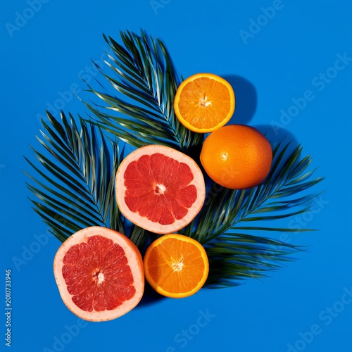 Fresh Fruits on Green Leaves Against a Blue Background in a Vibrant Setting
