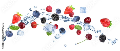 Fresh berries, water splash and ice cubes in air against white background