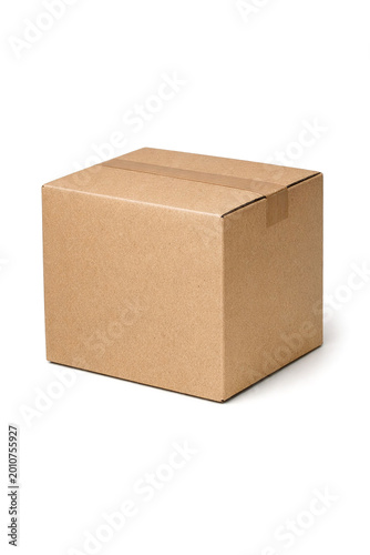 A plain, brown cardboard box sits against a light gray background. The box is sealed and ready for shipping or storage. Its simple design suggests it could hold various items securely.