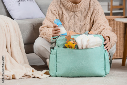 Woman with baby bag and bot...
