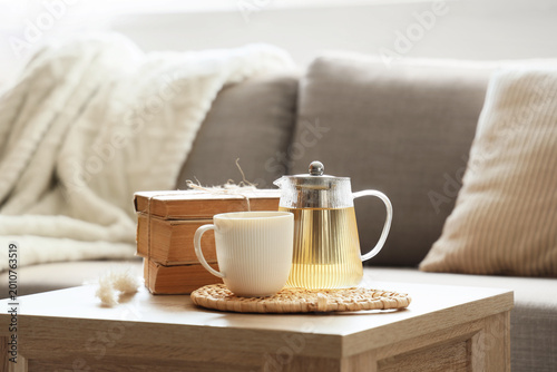 Glass teapot with cup of te...