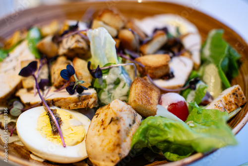 Caesar Salad with crisp romaine lettuce, crunchy croutons, and fresh parmesan cheese, served in a French restaurant