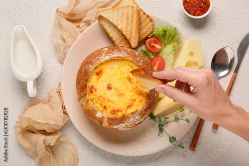 Female hand with cheese sou...