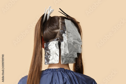 Young woman dyeing her hair...
