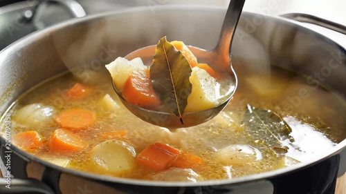Hearty Vegetable Stew Simmering in a Pot with Ladle.