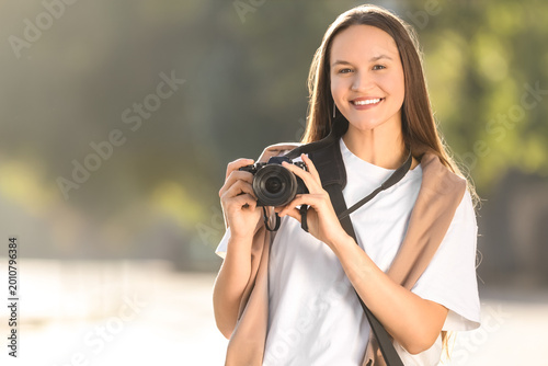 Young happy female photogra...