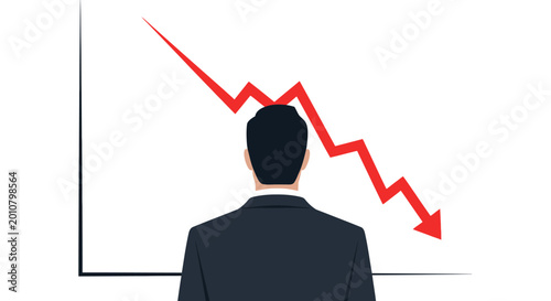 Businessman looking at a downward trending graph.