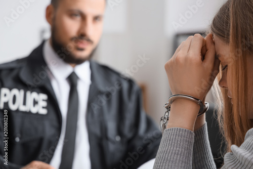 Upset woman with handcuffs ...