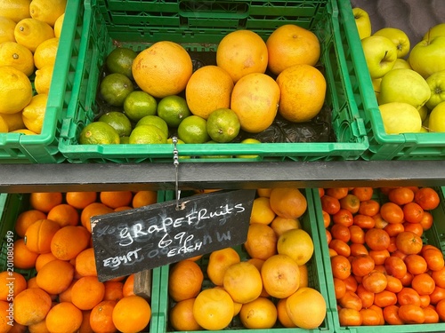 oranges, lemons, grapefruit, apples and tangerines outside the fruit shop