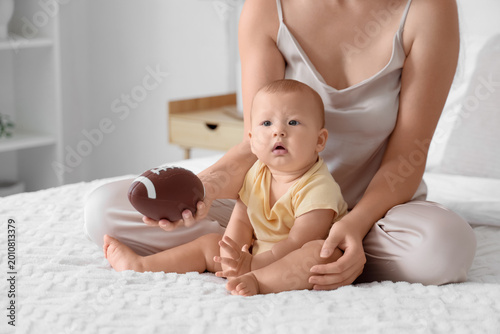 Mother with toy ball and he...