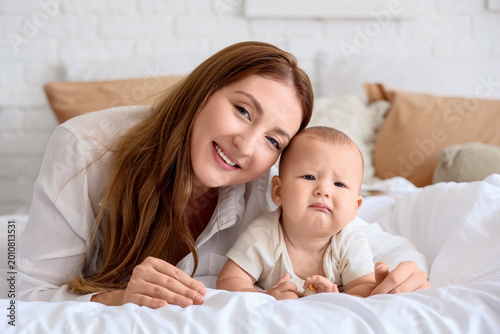 Mother with her baby lying ...