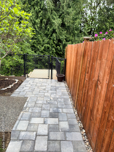 Stone pave pathway to lower deck of residential home in portrait layout format