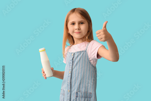 Cute little girl with bottl...