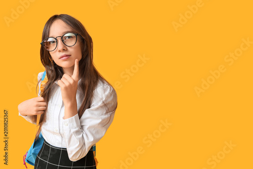 Cute schoolgirl in eyeglass...