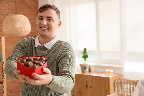Young man with box of heart...