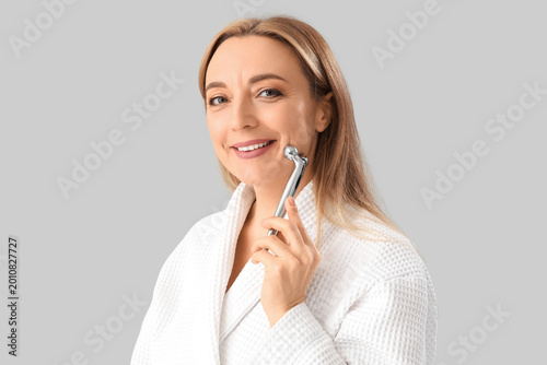 Mature woman in bathrobe ma...