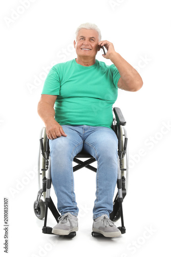 Mature man in wheelchair ta...