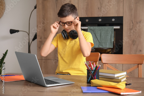 Little boy studying online ...