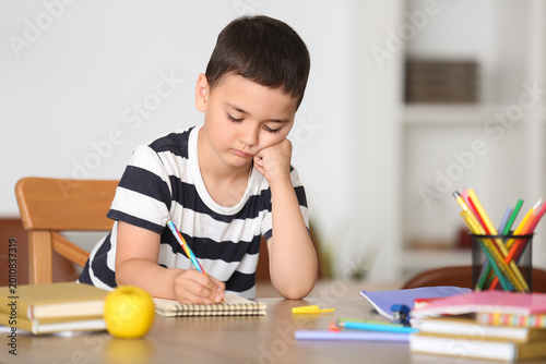 Tired little boy doing less...