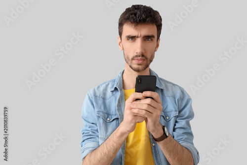 Thoughtful young man using ...